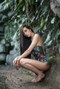 Girl in swimsuit near stone wall Royalty Free Stock Photo