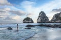 A girl in a swimsuit is standing on the stone. View of Diamond Beach, Nusa Penida, Bali, Indonesia. A small island in the ocean. Royalty Free Stock Photo