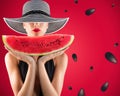 Girl in swimsuit with watermelon in hand and red background with seeds Royalty Free Stock Photo