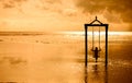 A girl on a swing over the sea at sunset in bali,indonesia 2