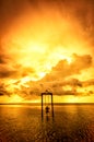 A girl on a swing over the sea at sunset in bali,indonesia 4 Royalty Free Stock Photo