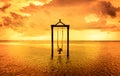 A girl on a swing over the sea at sunset in bali,indonesia 7 Royalty Free Stock Photo