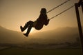 Girl on Swing at sunset Royalty Free Stock Photo