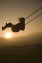 Girl on Swing at sunset Royalty Free Stock Photo