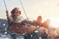 Girl on swing in sunset winter Royalty Free Stock Photo