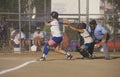 Girl swinging bat at Girls Softball game