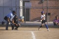 Girl swinging bat at Girls Softball game