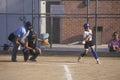 Girl swinging bat at Girls Softball game in Brentwood, CA