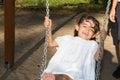 girl swinging on the playground with mother hand to push Royalty Free Stock Photo