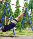 Girl swinging swing in the garden. Royalty Free Stock Photo