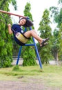 Girl swinging swing in the garden. Royalty Free Stock Photo