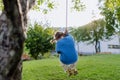 Girl swinging on a swing in the garden. Schoolgirl spending free time with her grandparents in the garden on a warm Royalty Free Stock Photo