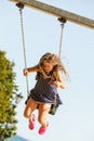 Girl swinging on swing-set. Royalty Free Stock Photo