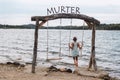 Girl swinging on a wooden swing against the background of the sea. Murter, Croatia Royalty Free Stock Photo