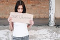 Girl in a T-shirt with a Cardboard in her hands. Save Ukraine call on people to come out