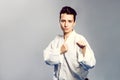 Girl, Taekwondo is martial Stoke hands in fists, focused, serious look in the Studio on gray isolated background Royalty Free Stock Photo