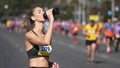 Girl take a break. Woman athlete drinking water bottle . Thirsty runner resting.