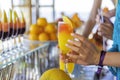 Girl take a glass with natural juice from the bar near the pool. Summer luxury tropical restaurant. Elegant cocktails Royalty Free Stock Photo