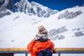 The girl take a photo pf Jade dragon Snow Mountain in Lijiang, Yunnan, China