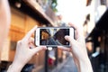 Girl take picture of quiet little street of Kyoto near Gion district with Iphone, instagram blogger concept, Japan