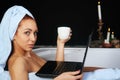 Girl takes a bath and is working with laptop Royalty Free Stock Photo