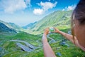 The girl takes a photo of Transfagarasan mountain road. Romania. Royalty Free Stock Photo