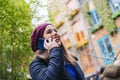 Girl takes a picture with the mobile phone in the street of a picturesque town Royalty Free Stock Photo