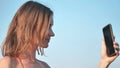 The girl takes a selfie on the city beach. Royalty Free Stock Photo