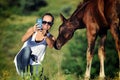 Girl takes selfie with foal