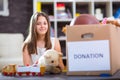 Girl taking donation box full with stuff for donate Royalty Free Stock Photo