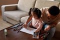 Girl take felt-tip pen during draw with father