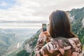 Girl taking photo with her phone in nature