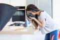 Girl taking photo of pizza in studio