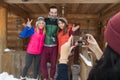 Girl Taking Photo On Smart Phone People Group Wooden Country Mountain House Winter Snow Resort Royalty Free Stock Photo