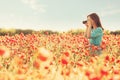 Girl taking photographs with camera in flower meadow. Royalty Free Stock Photo