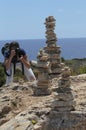 Girl taking photographs next to Stone mounts in the south coast of the island of majorca