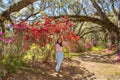 Girl taking photos with her phone in beautiful  blooming garden. Royalty Free Stock Photo