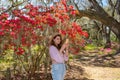 Girl taking photos with her phone in beautiful  blooming garden. Royalty Free Stock Photo