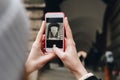 Girl taking picture by phone in city Royalty Free Stock Photo