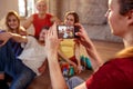 Girl taking picture of smiling dancer friends Royalty Free Stock Photo