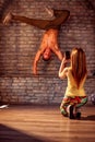 Girl taking picture of smiling street artist break dancing performing moves Royalty Free Stock Photo