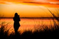 Girl taking a picture of the sunset