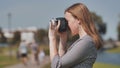 A girl taking pictures with her camera on a summer day. Royalty Free Stock Photo