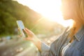 Girl taking pictures of a landscape, close-up of a phone in her Royalty Free Stock Photo