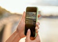 Girl taking pictures of a landscape, close-up of a phone in her Royalty Free Stock Photo