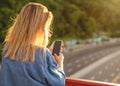 Girl taking pictures of a landscape, close-up of a phone in her Royalty Free Stock Photo