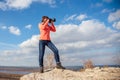 Girl taking pictures of the landscape