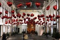 Girl taking pictures of the street, decorated for Valentine`s Da