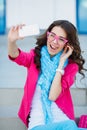 Girl taking pictures of yourself on your cell phone Royalty Free Stock Photo