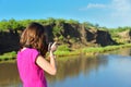 Girl taking river photo by camera Royalty Free Stock Photo